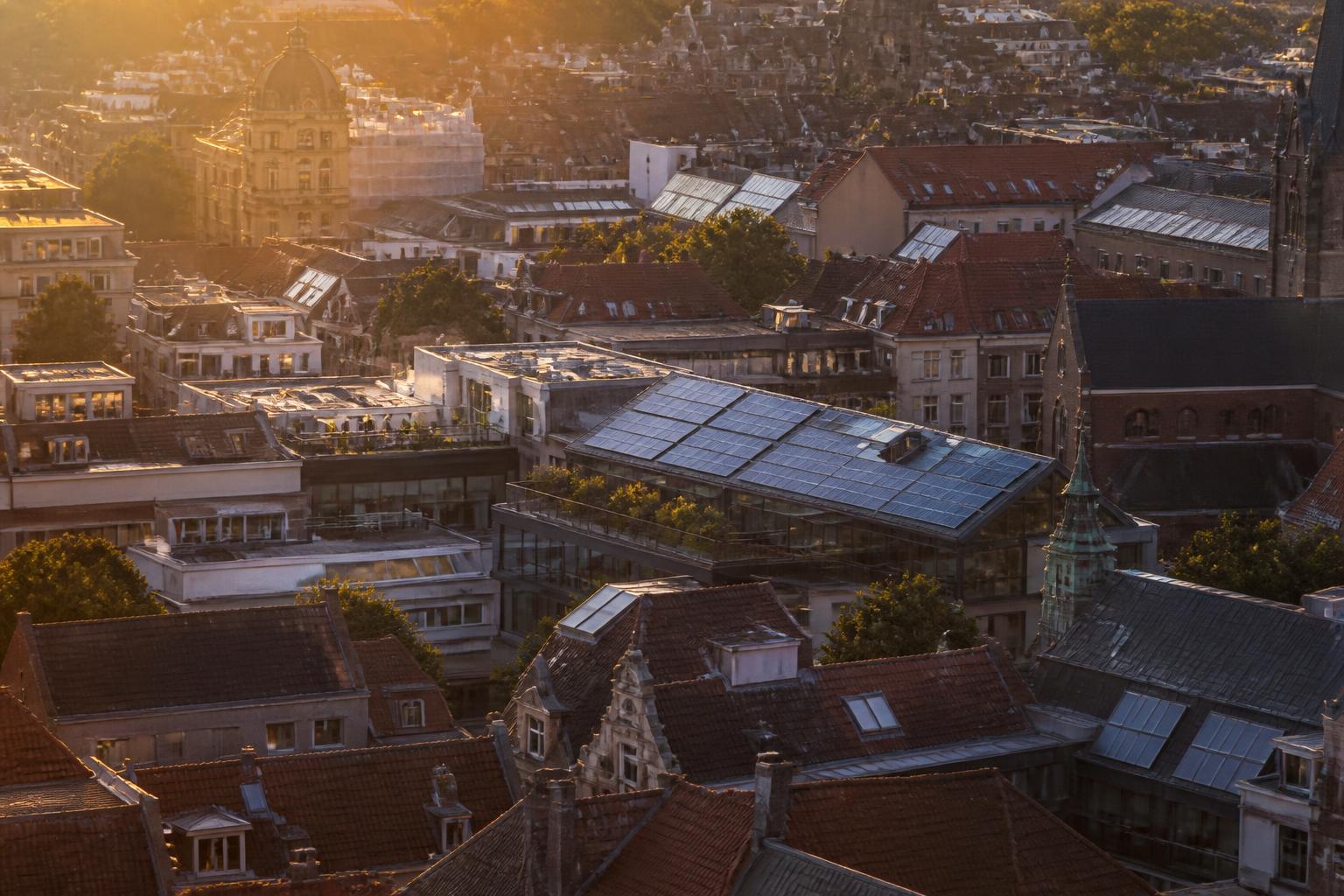 European rooftops with photovoltaic arrays at golden hour
